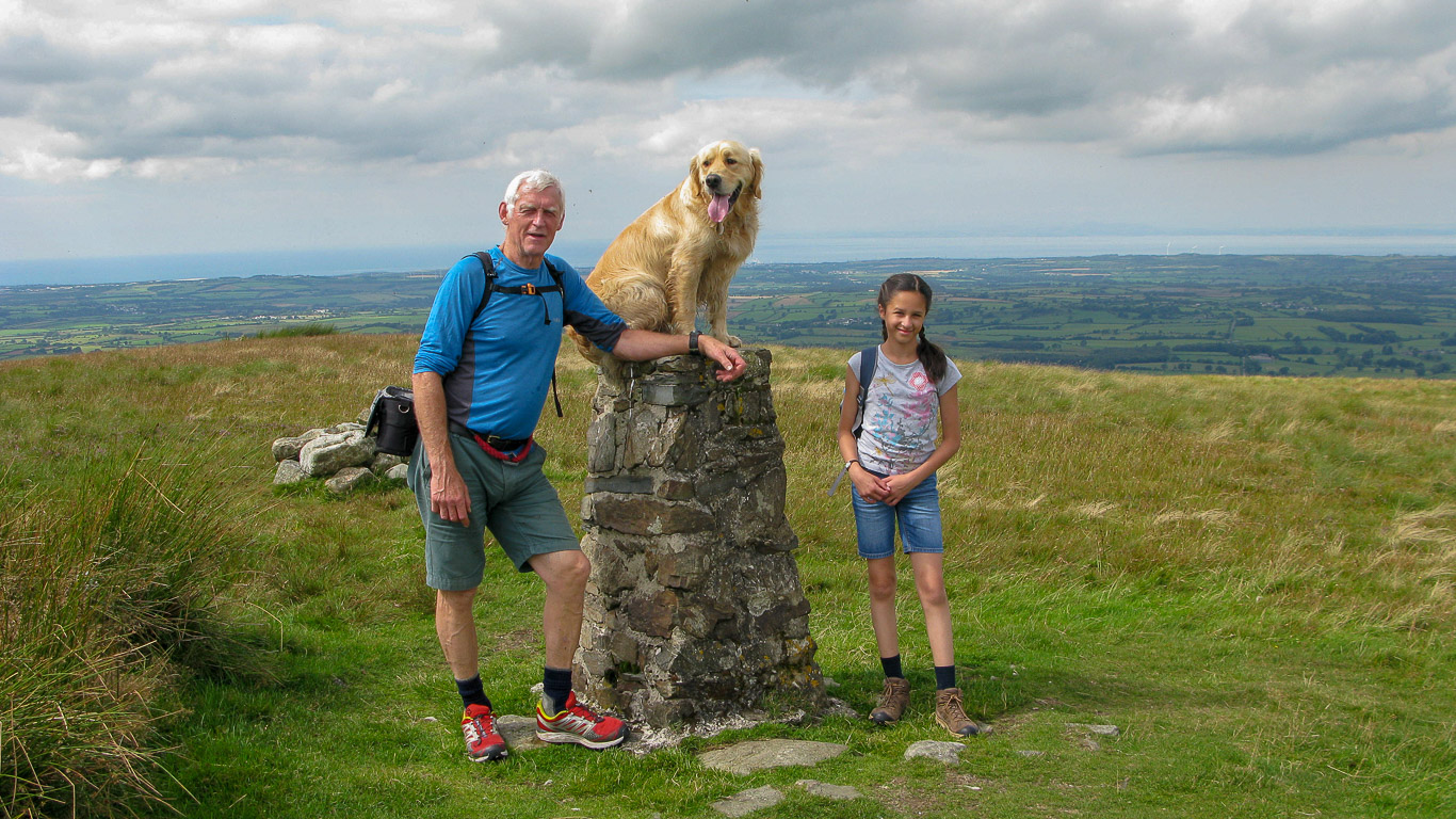 Roger Hiley Dylan and Mila on the summit Trig -point pillar on Fellbarrow